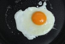 A wife was making a breakfast of fried eggs for her husband.