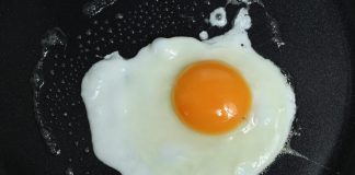 A wife was making a breakfast of fried eggs for her husband.