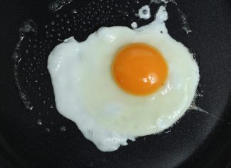 A wife was making a breakfast of fried eggs for her husband.